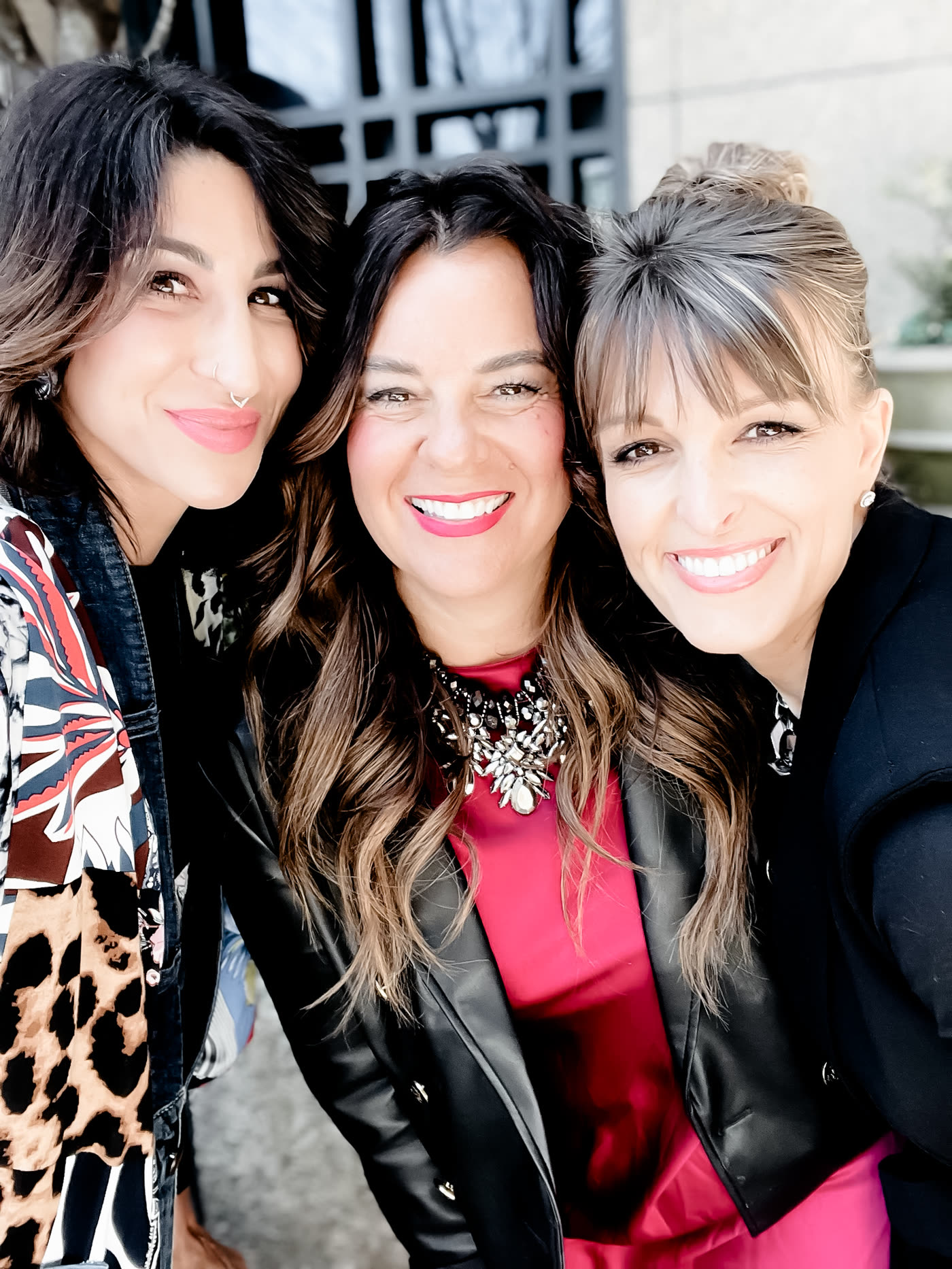The three founders of The Transformation Triad together, heads close, laughing