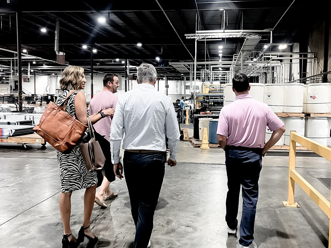 The Triad walking a client through a distribution warehouse floor